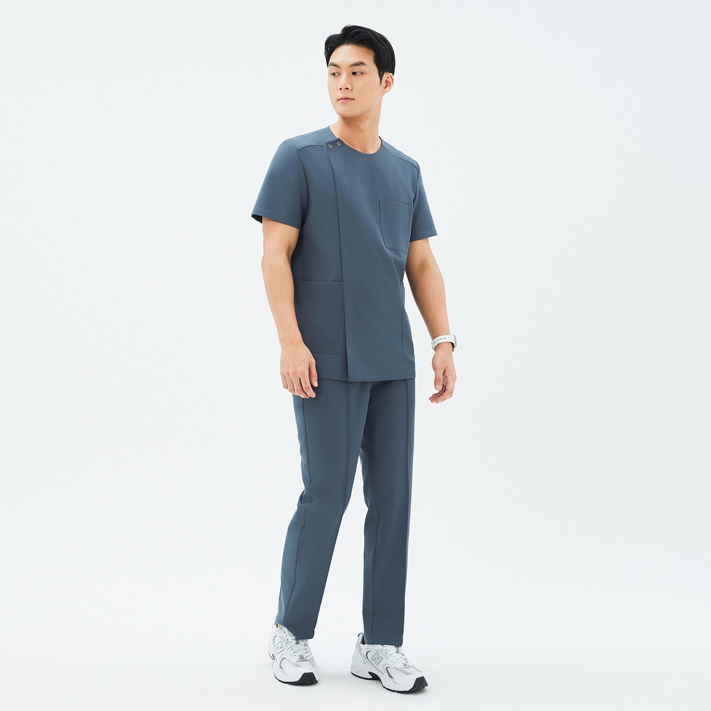 Male model wearing the TUL Men's Premium Banding Pants in Haze Gray with a matching top, standing in a relaxed pose.