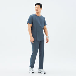 Image of Male model wearing the TUL Men's Premium Banding Pants in Haze Gray with a matching top, standing in a relaxed pose.