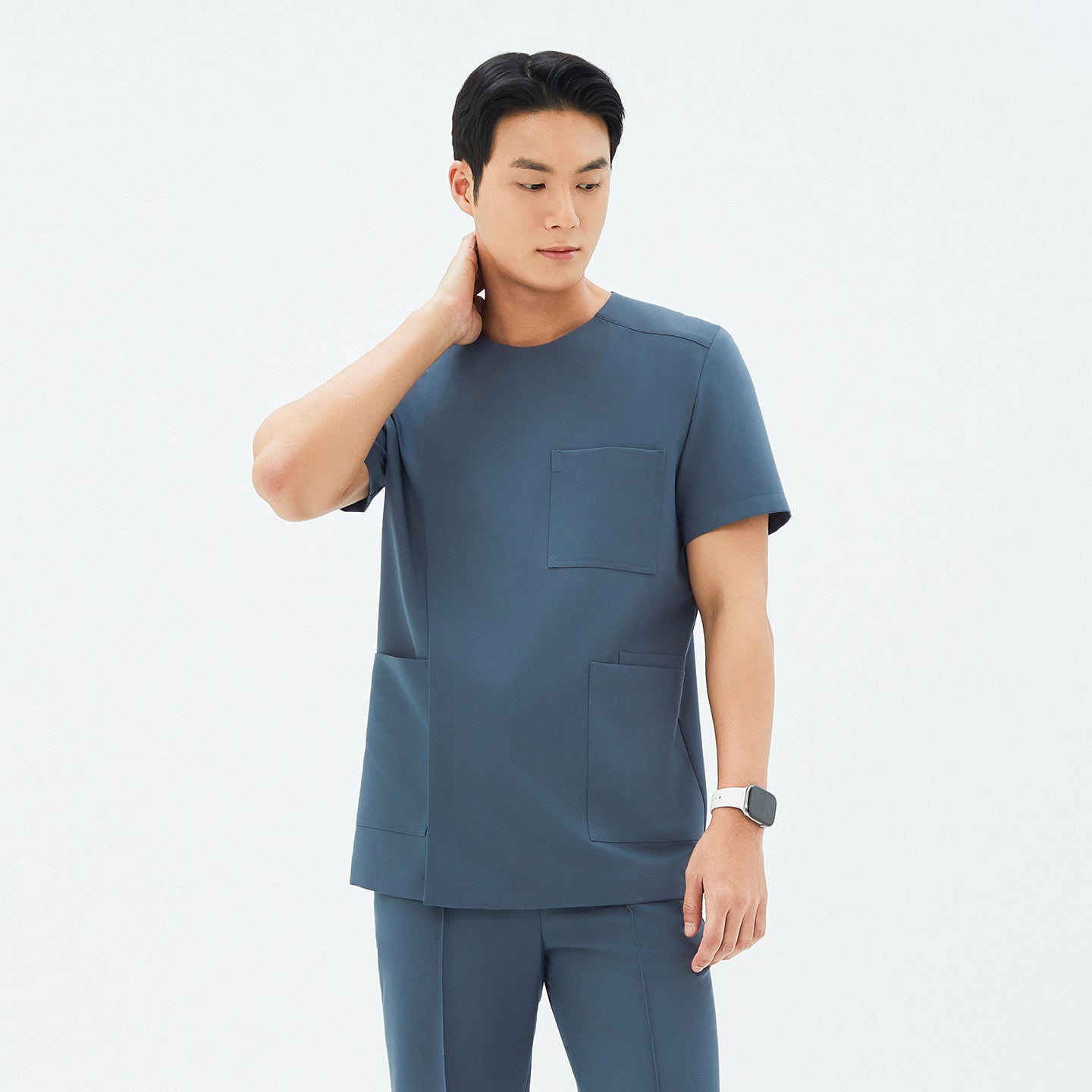 Front angle of TUL DS-190 Men's Round Snap Zipper Scrub Top in Haze Gray, featuring a snap collar detail and short sleeves.