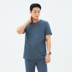 Image of Front angle of TUL DS-190 Men's Round Snap Zipper Scrub Top in Haze Gray, featuring a snap collar detail and short sleeves.