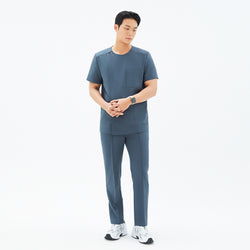 Image of Full-length view of TUL DS-190 Men's Round Snap Zipper Scrub Top in Haze Gray, paired with matching pants for a cohesive uniform look.