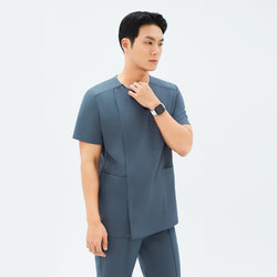 Image of Side angle of TUL DS-190 Haze Gray scrub top, highlighting spacious front pockets and a tailored fit.