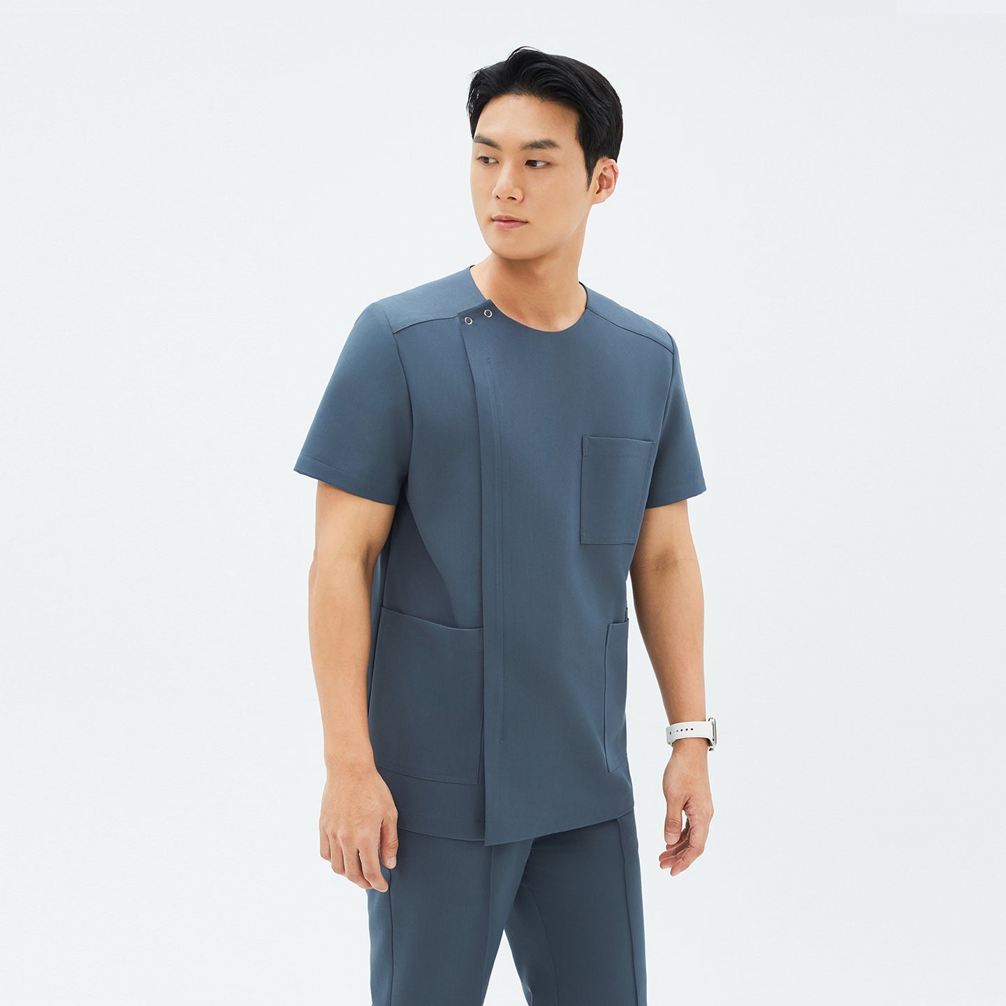 Image of Another angle of TUL DS-190 Men's Round Snap Zipper Scrub Top in Haze Gray, featuring short sleeves and a modern, structured design.