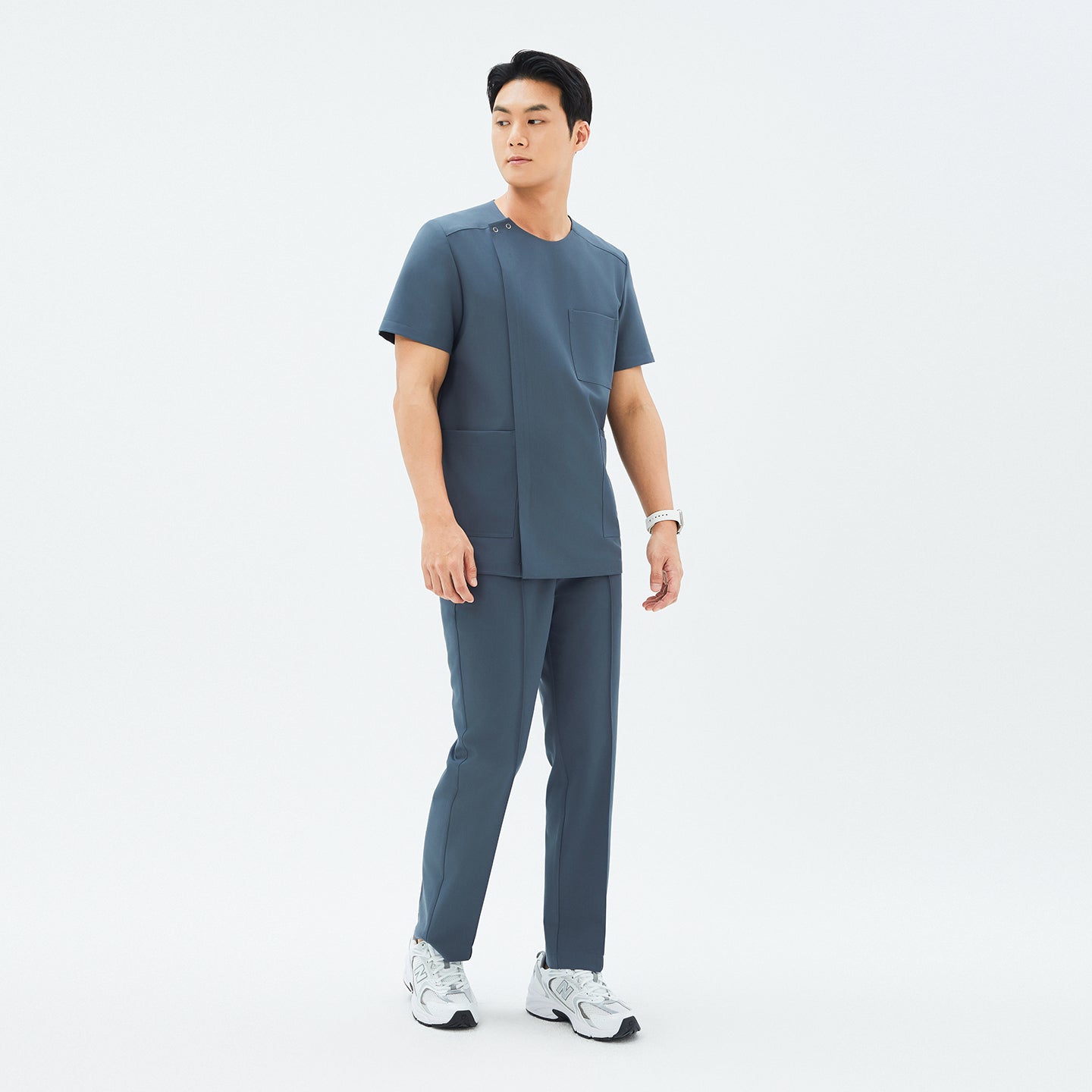 Image of Full outfit featuring TUL DS-190 Men's Round Snap Zipper Scrub Top in Haze Gray, paired with matching pants and sneakers for a professional yet comfortable look.