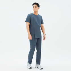 Image of Full outfit featuring TUL DS-190 Men's Round Snap Zipper Scrub Top in Haze Gray, paired with matching pants and sneakers for a professional yet comfortable look.