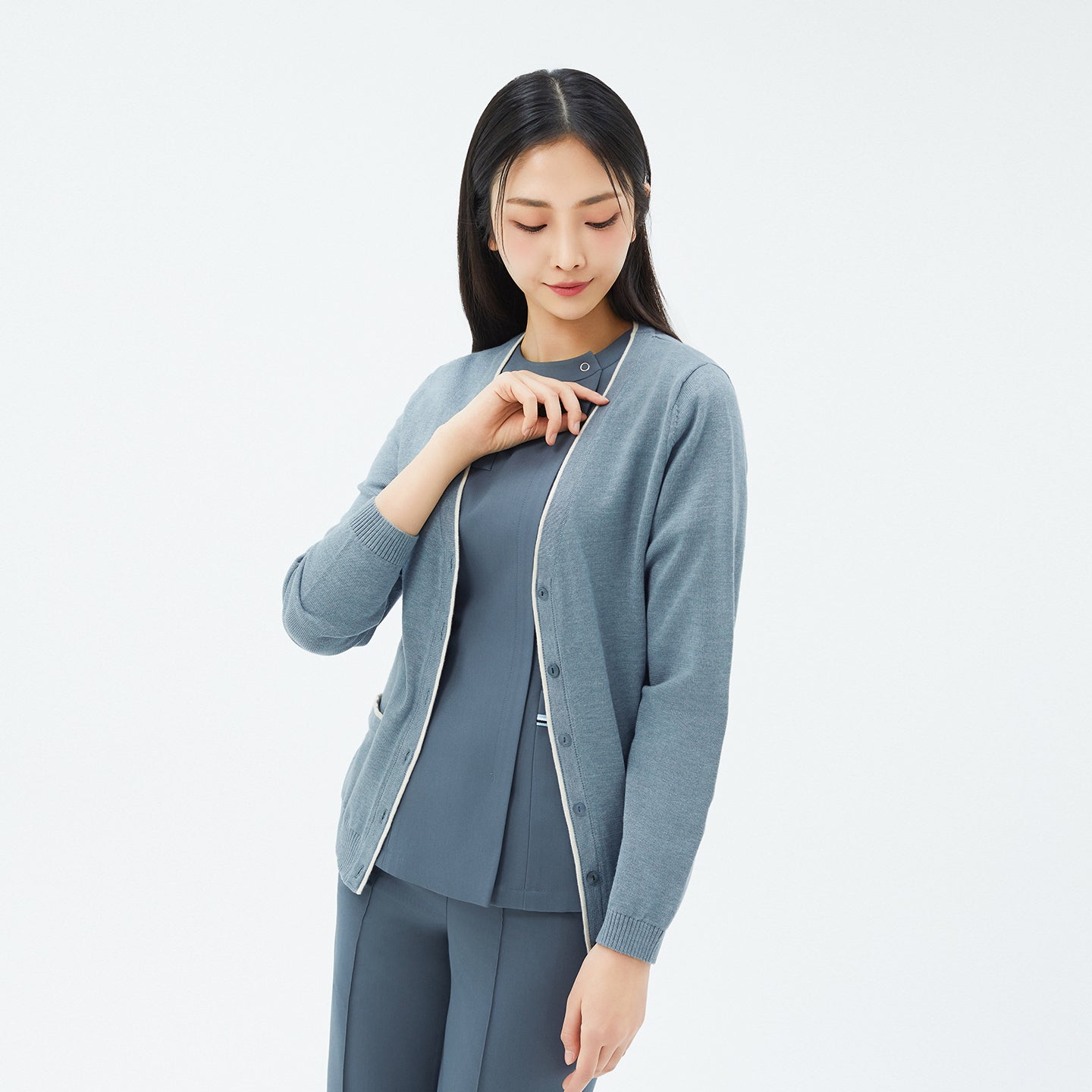 Image of Front view of TUL CD-99 Essential Knit Cardigan in Soft Mint Gray, worn over matching scrubs.