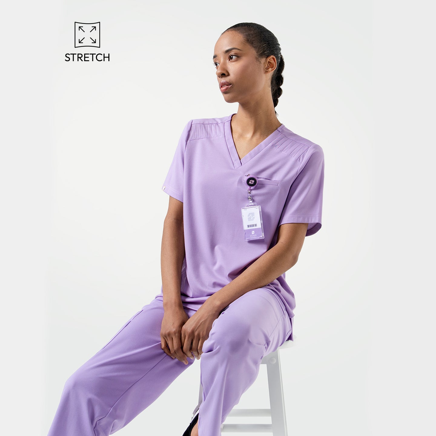 Lavender  scrub top with shoulder details, paired with matching scrub pants