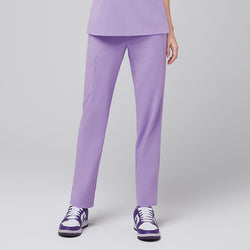 Image of Model wearing lavender scrub pants, featuring a side pocket and purple sneakers,Lavender