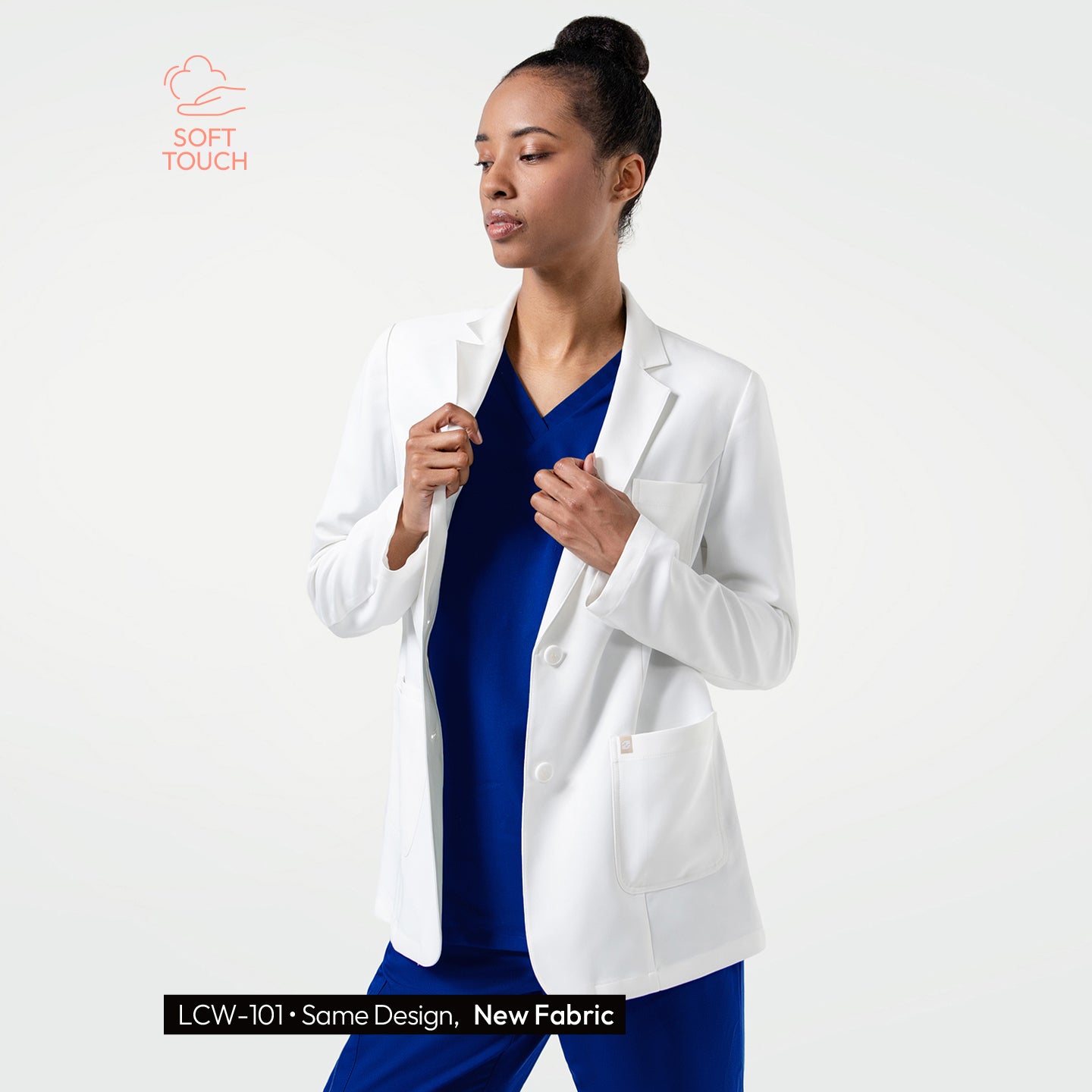 Image of Defined by a sleek, contemporary silhouette, the LCW-201 lab coat is displayed on the model as she poses confidently, revealing its balanced proportions, structured lapels, and clean finish over blue medical wear.