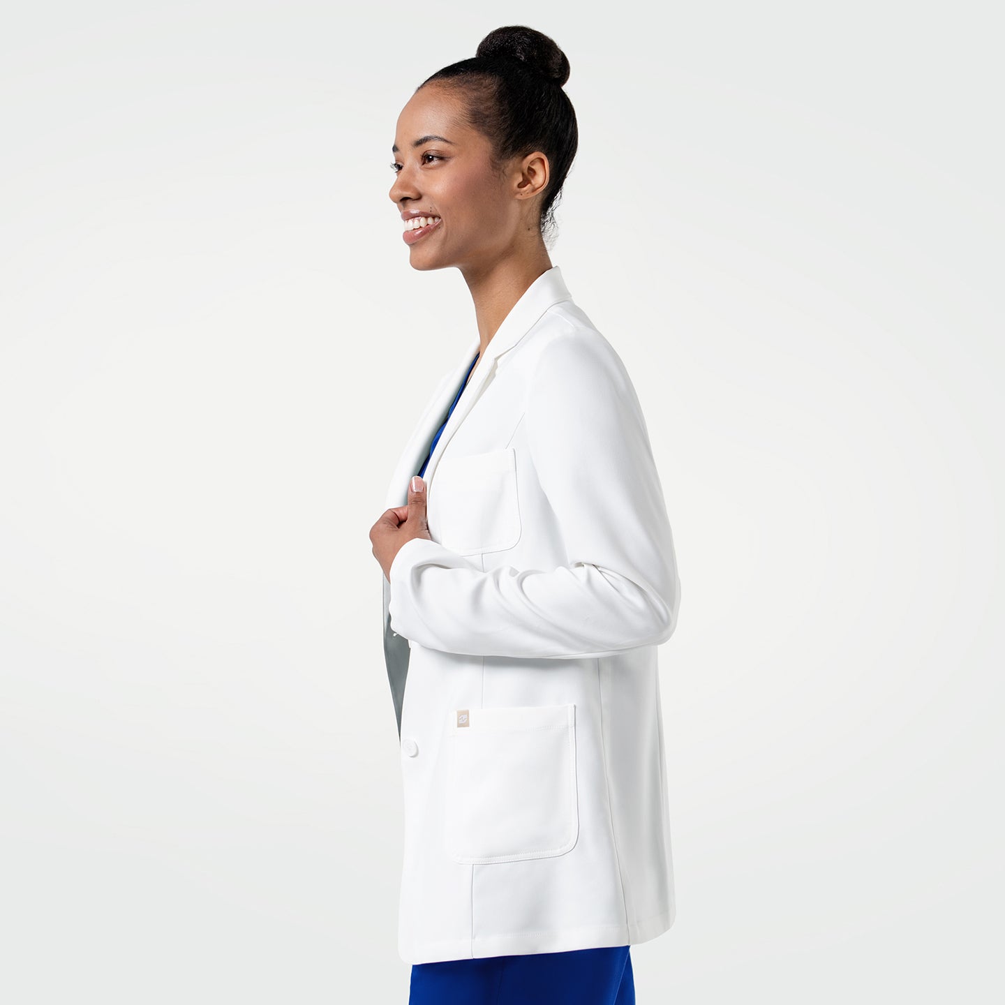 Image of The LCW-201 lab coat features a clean, structured silhouette in crisp white, offering a polished professional look enhanced by thoughtfully placed pockets and a smooth, flexible fabric that supports comfort and ease of movement throughout long shifts.