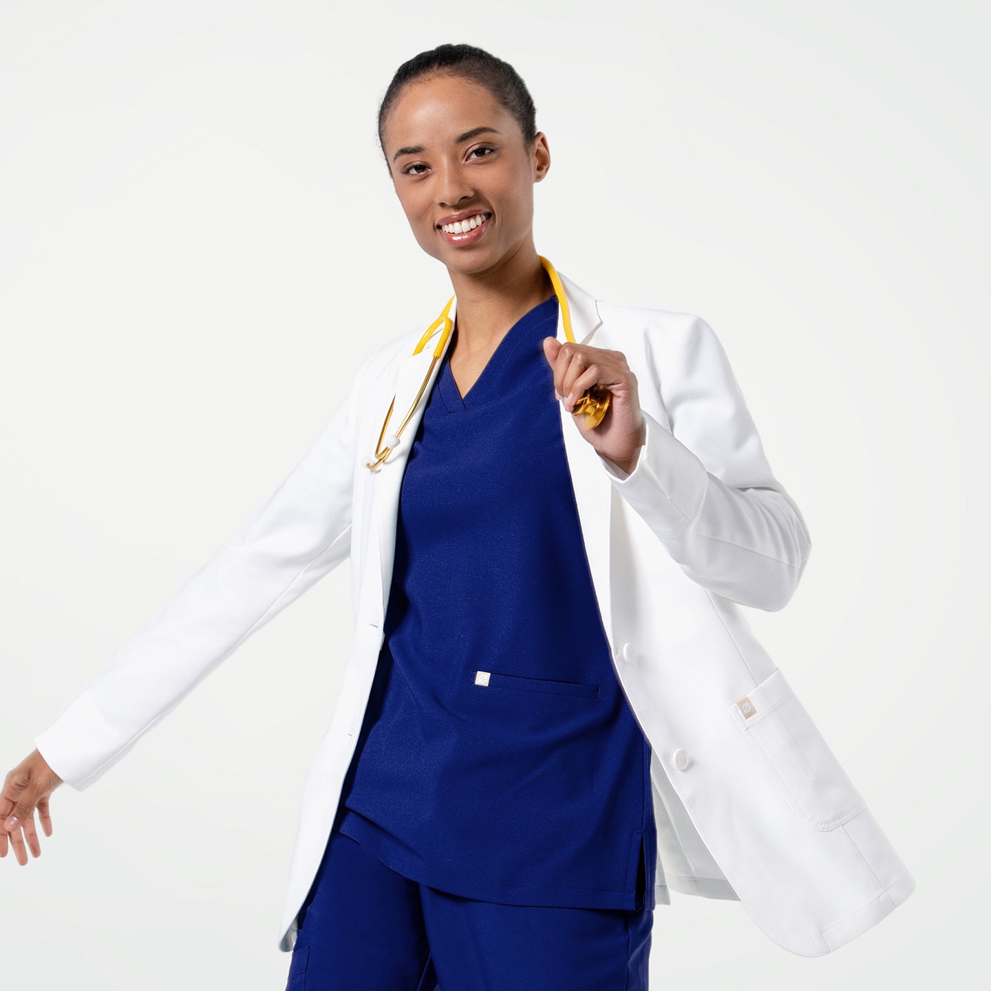 Image of Smiling confidently, the model wears the LCW-202 lab coat over a royal-blue scrub set, showing the coat’s clean structure, soft drape, and smooth lapels as she moves with ease.