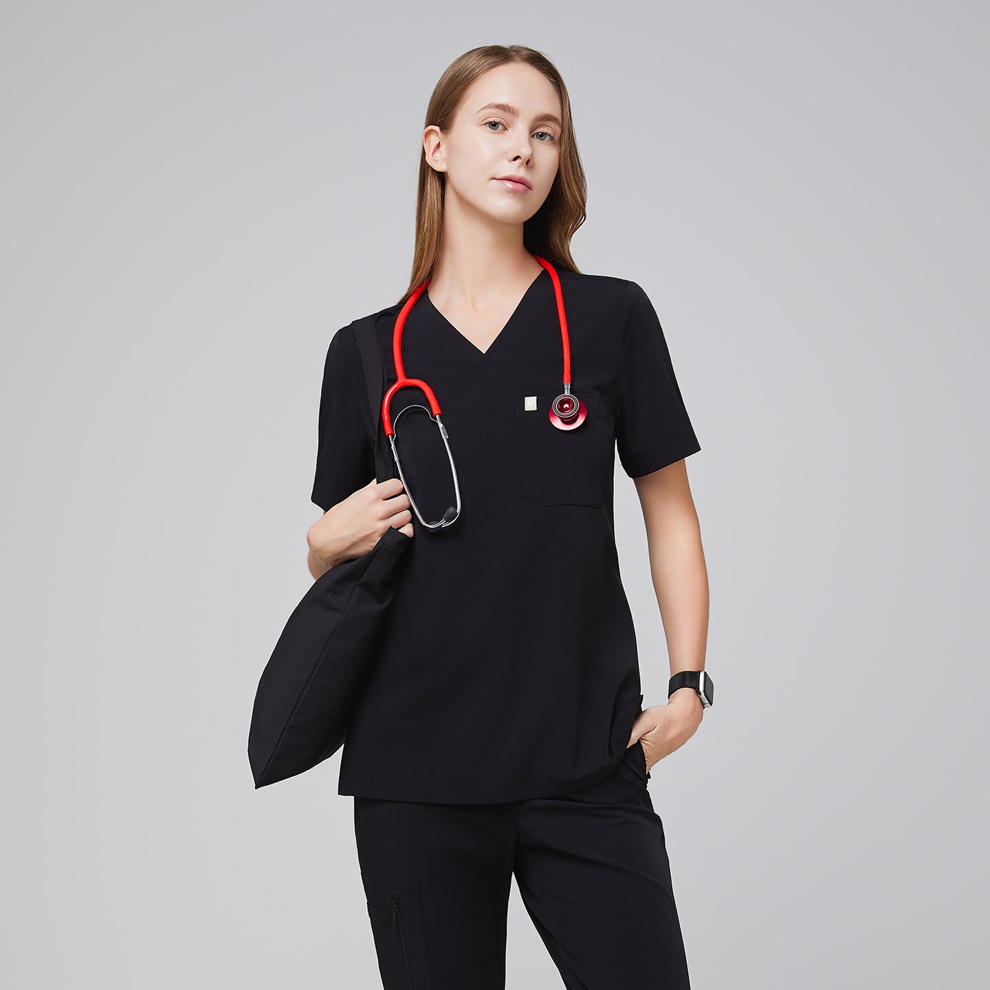 Image of Female healthcare professional wearing a midnight black scrub set with a red stethoscope, holding a black bag in a confident pose,Midnight Black