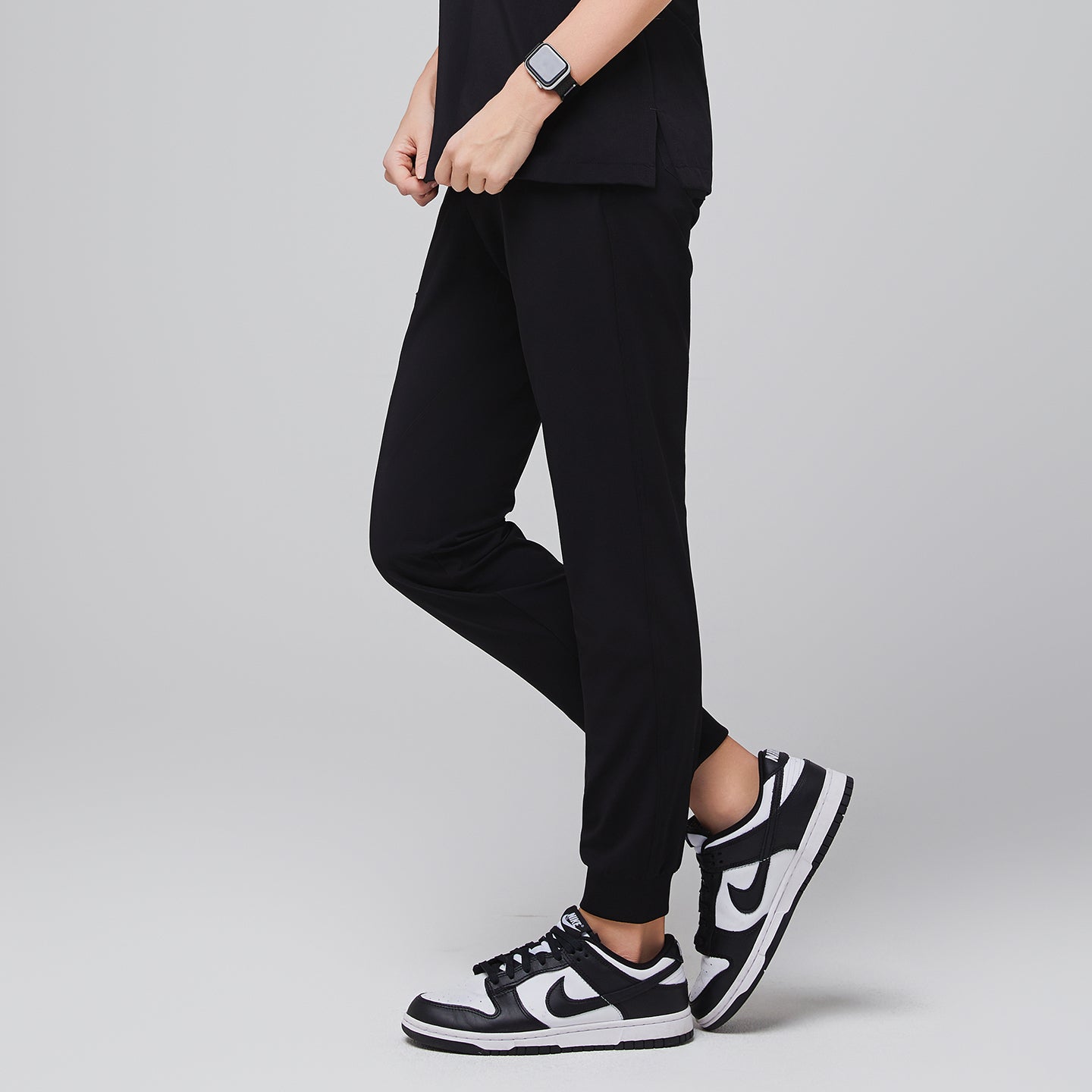 Image of Jogger-style scrub pants worn by a medical professional with sneakers and a smartwatch,Midnight Black