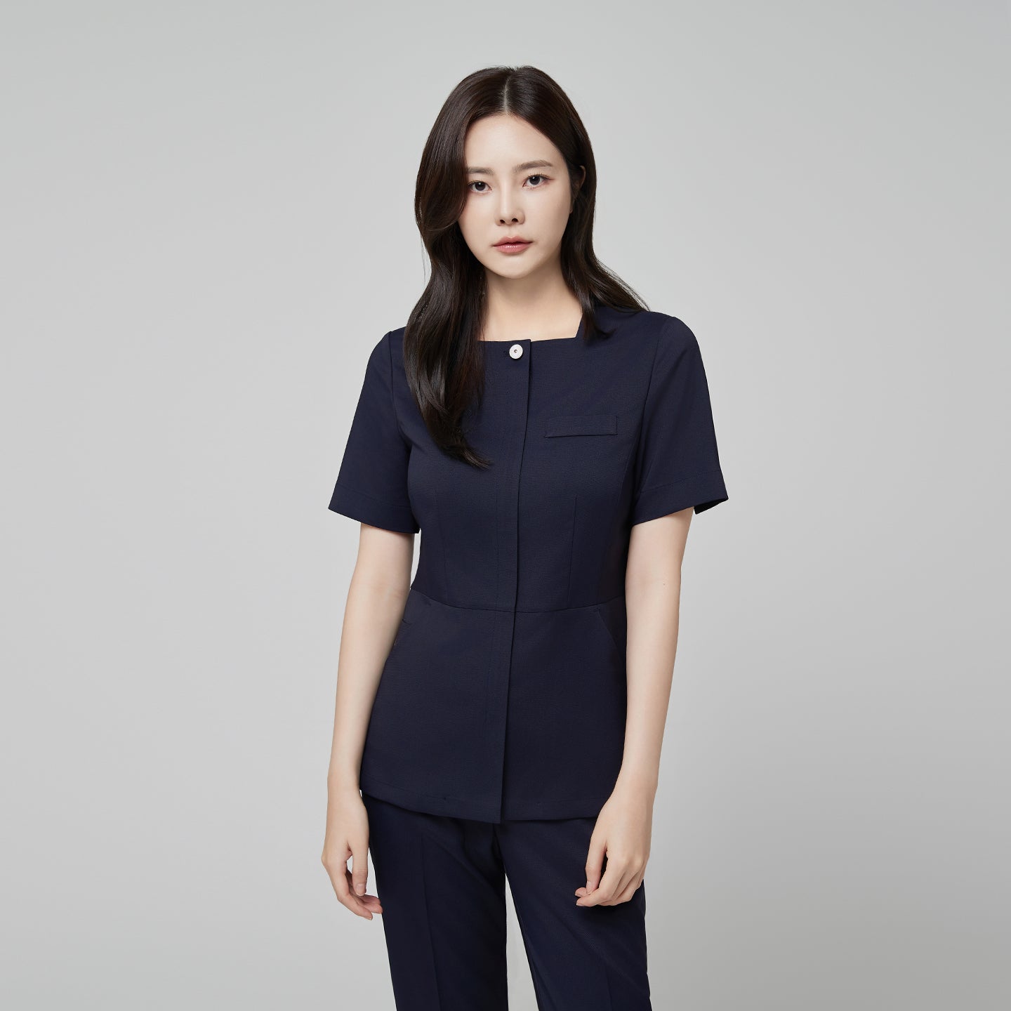 Front view of TUL NS-172 Women’s Modern Square Collar Scrub Top in Mir Navy, highlighting a sleek square neckline and button detail.
