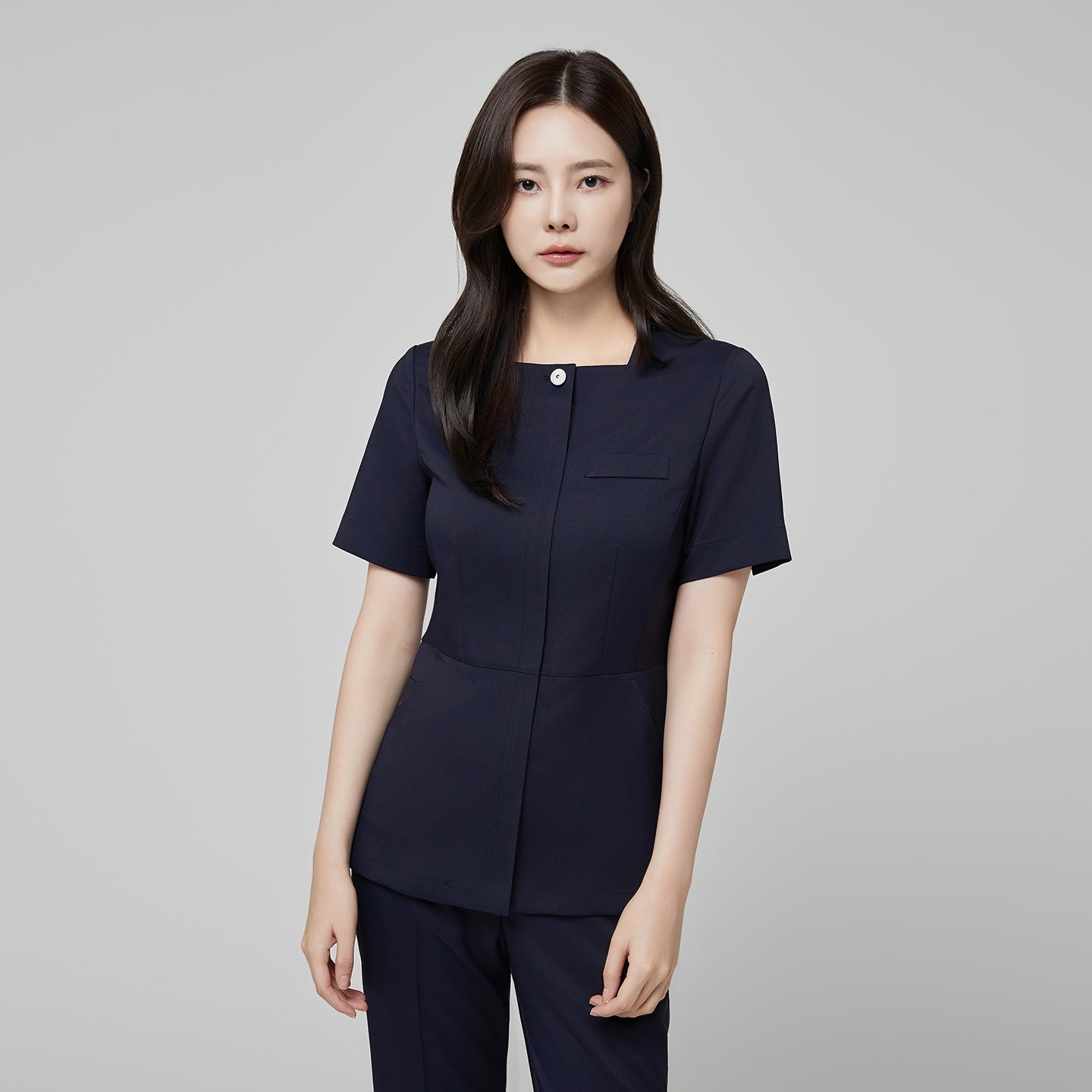 Image of Front view of TUL NS-172 Women’s Modern Square Collar Scrub Top in Mir Navy, highlighting a sleek square neckline and button detail.