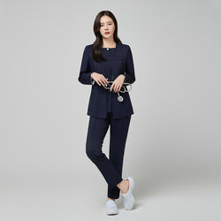Image of Full-length shot of a model wearing the TUL NS-172 Women's Modern Square Collar Scrub Top in Mir Navy, paired with matching pants for a cohesive professional look.