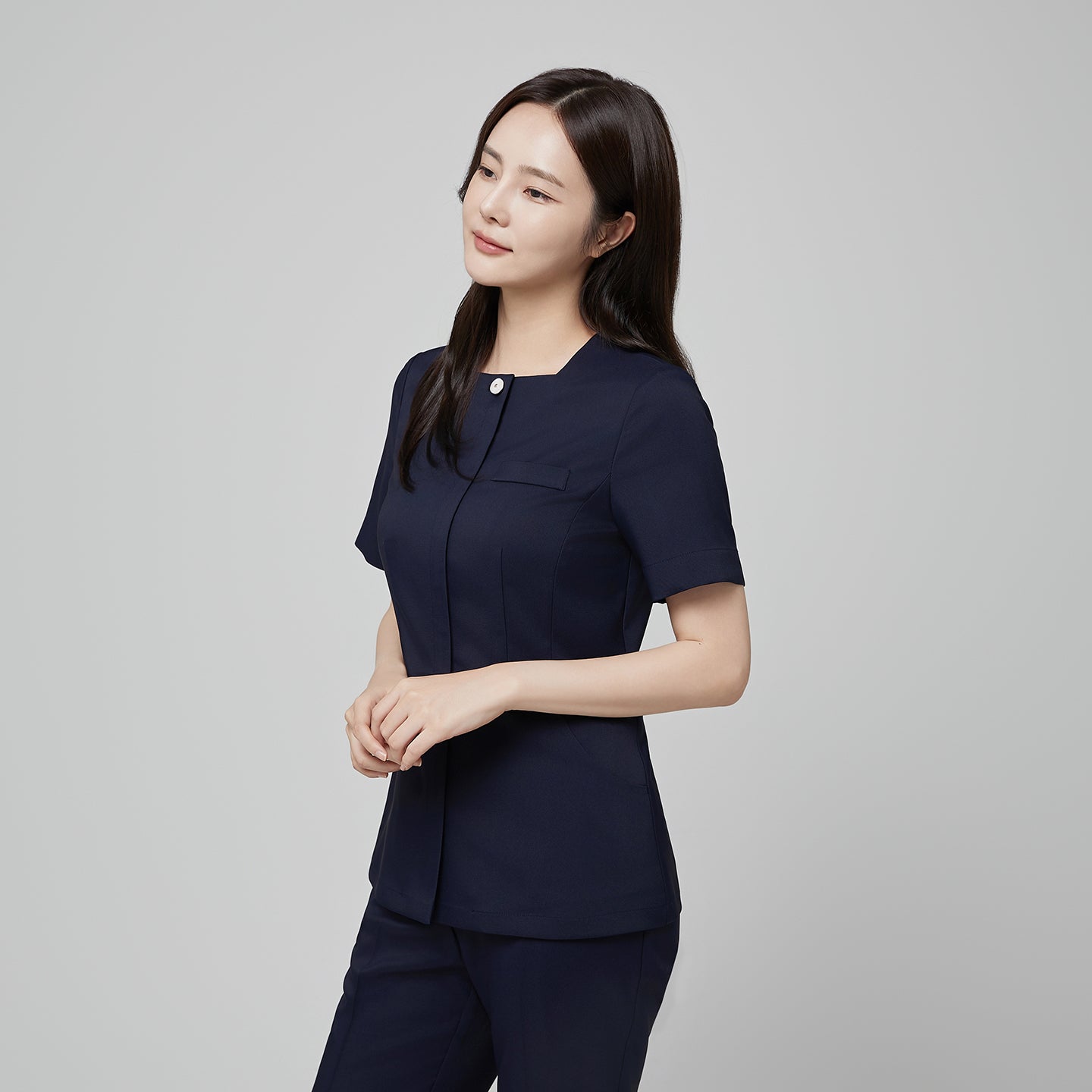 Angled shot of TUL NS-172 Mir Navy scrub top, showing structured seams and a refined, professional fit.