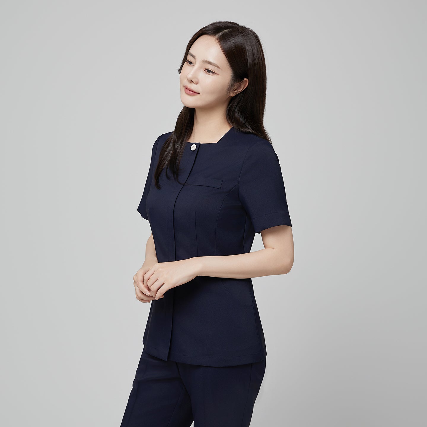 Image of Angled shot of TUL NS-172 Mir Navy scrub top, showing structured seams and a refined, professional fit.