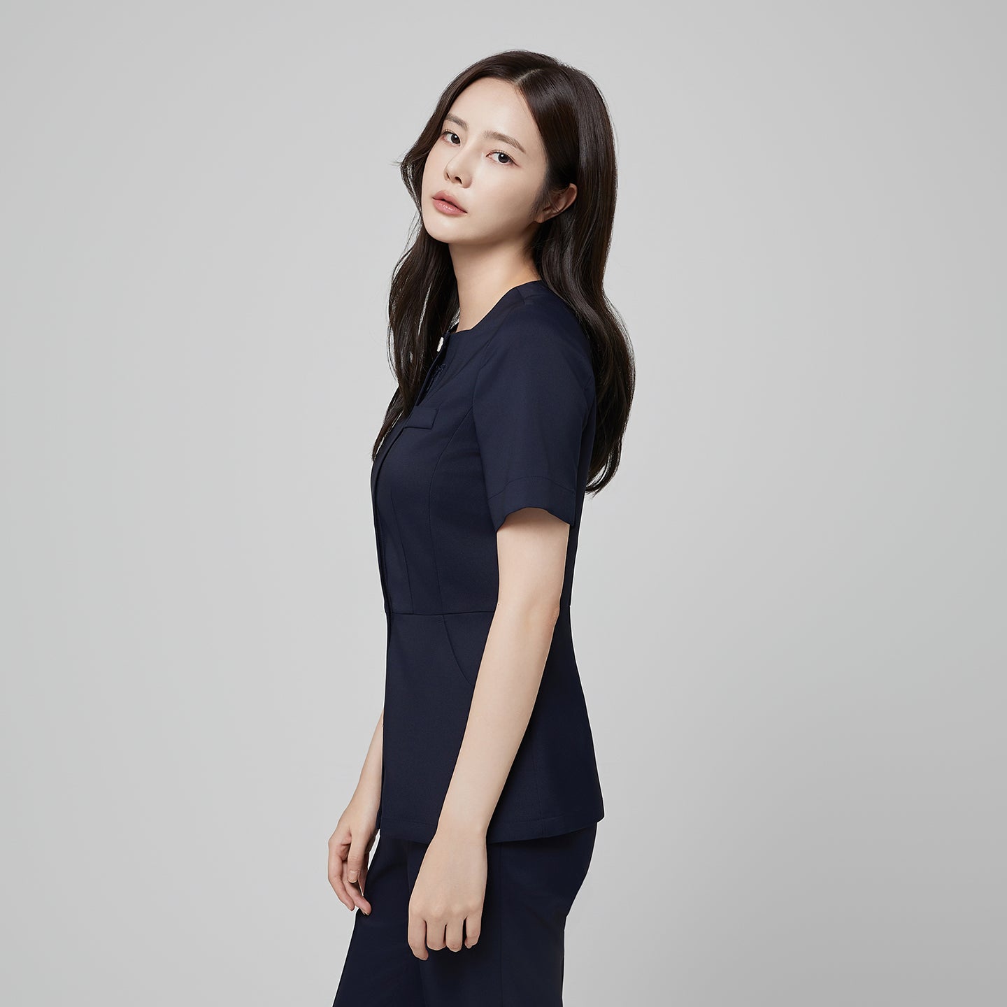 Image of Front angle of TUL NS-172 Mir Navy scrub top, emphasizing the tailored silhouette, short sleeves, and modern square collar.