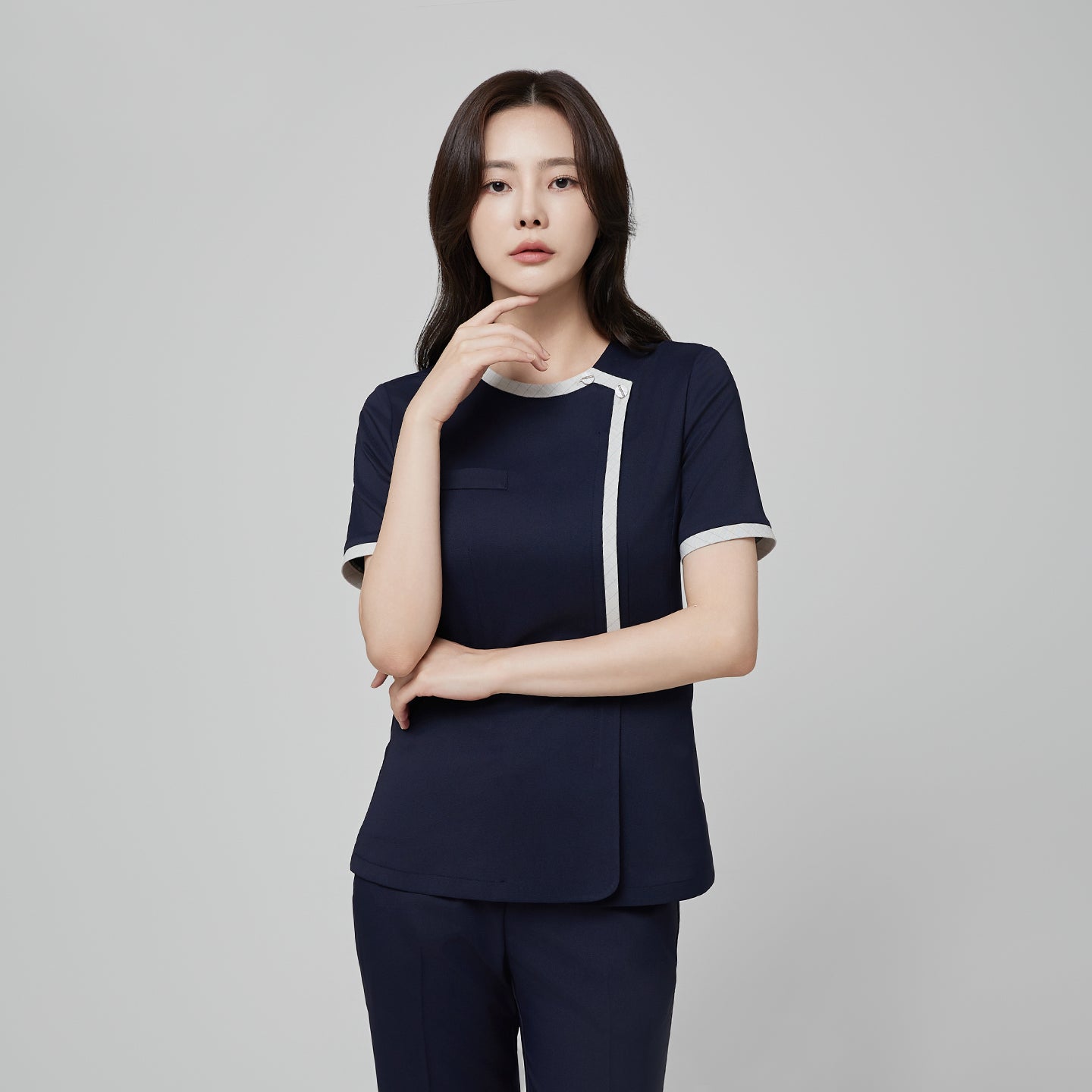 Front angle of TUL NS-174 Women’s Check Gray Round Collar Scrub Top in Mir Navy, highlighting short sleeves and a tailored silhouette.
