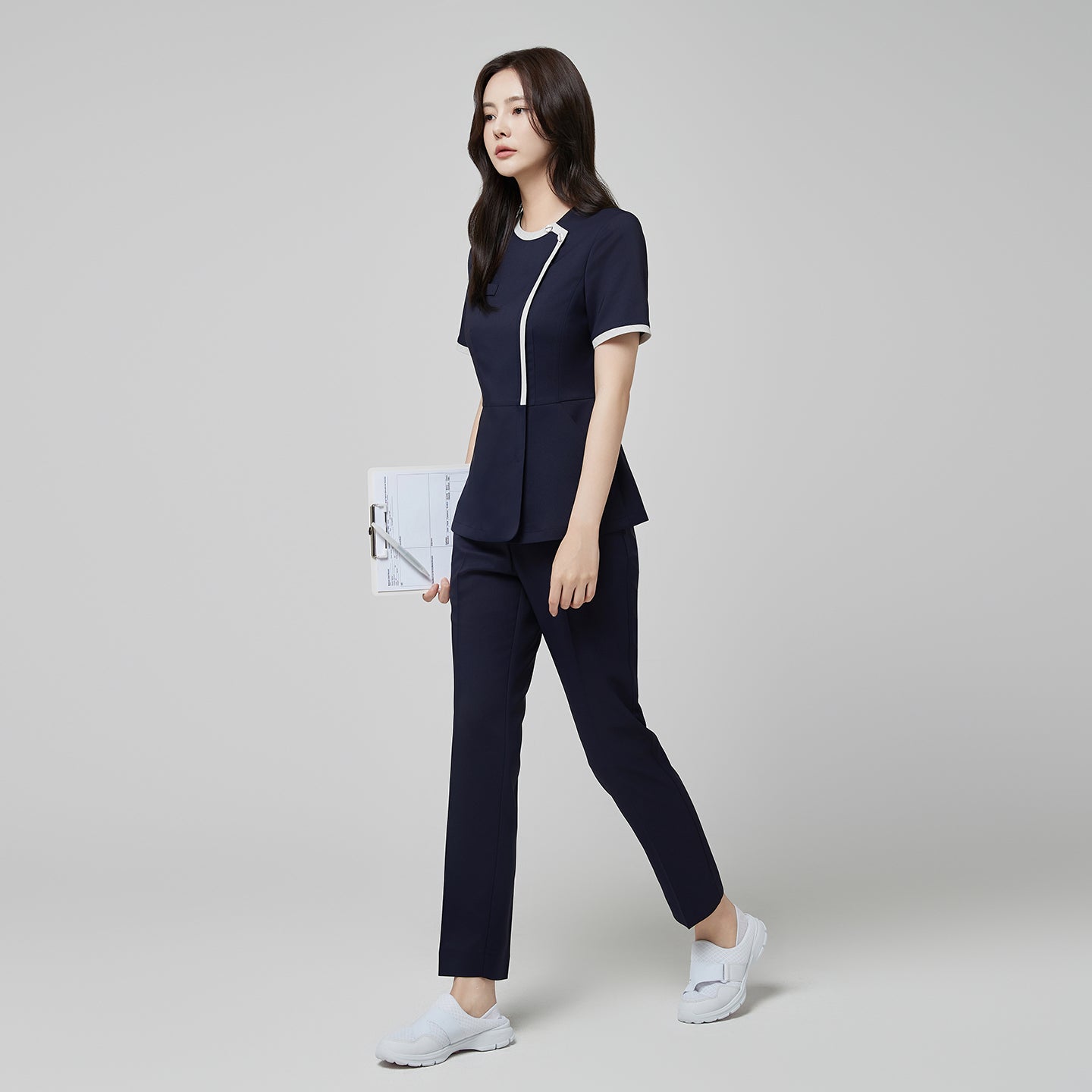 Full-length view of TUL NS-174 Mir Navy scrub top with check gray accents, paired with matching pants for a cohesive professional uniform.