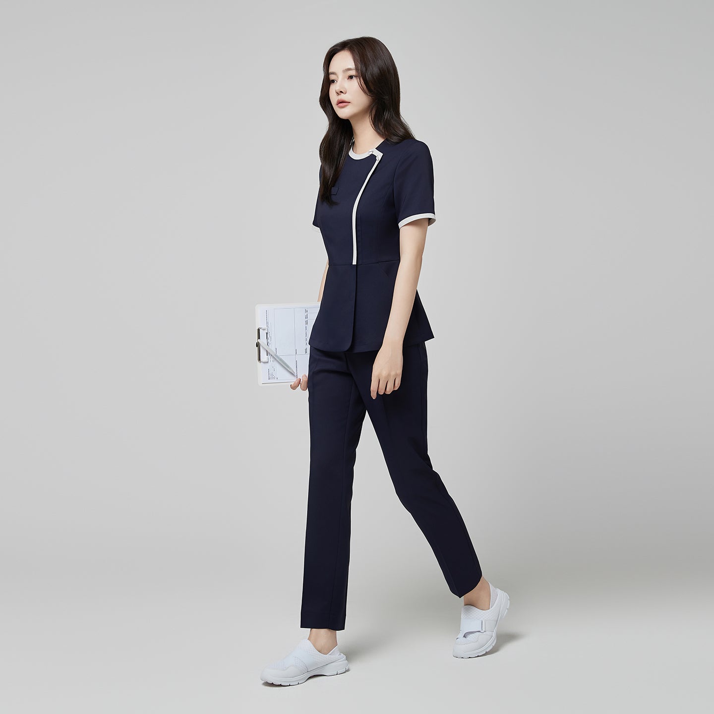 Image of Full-length view of TUL NS-174 Mir Navy scrub top with check gray accents, paired with matching pants for a cohesive professional uniform.