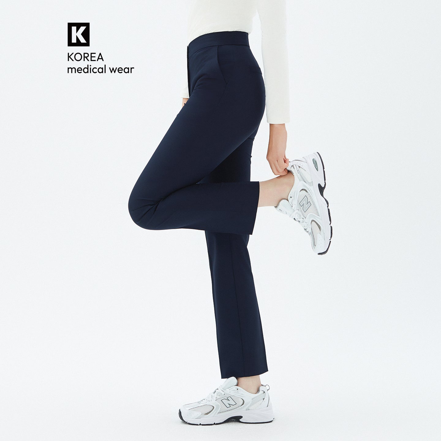 Image of Model lifting one leg while wearing TUL Women’s Side Hidden Banding Pants in Mir Navy, emphasizing a comfortable stretch and a tailored silhouette.