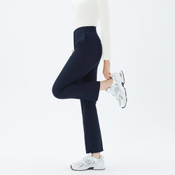 Image of Model lifting one leg while wearing TUL Women’s Side Hidden Banding Pants in Mir Navy, emphasizing a comfortable stretch and a tailored silhouette.