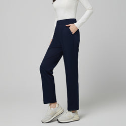 Image of Model wearing TUL Women's Premium Banding Pants in Mir Navy, paired with a matching scrub top for a cohesive, professional look.