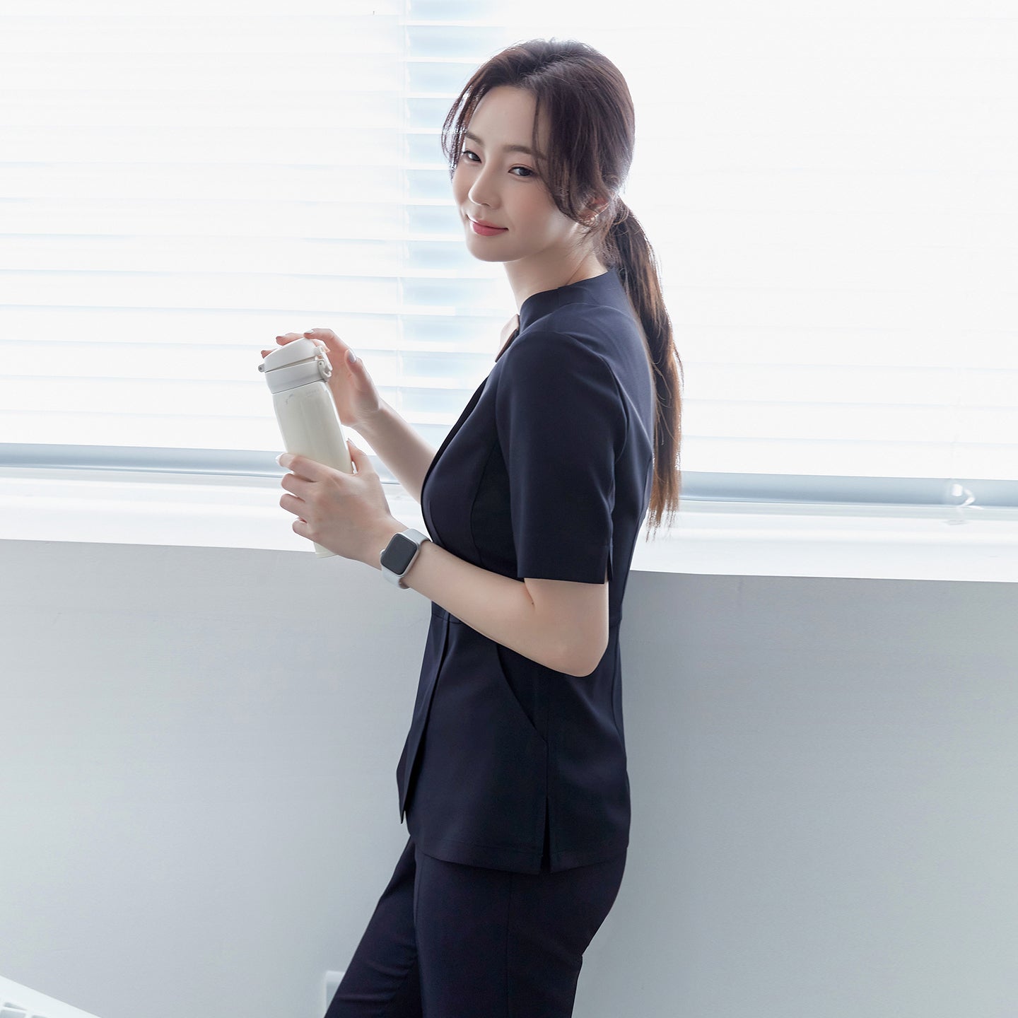 Image of TUL NS-150 Women's Round Collar Scrub Top in Navy, showing a comfortable short-sleeve design and contrasting beige neckline.