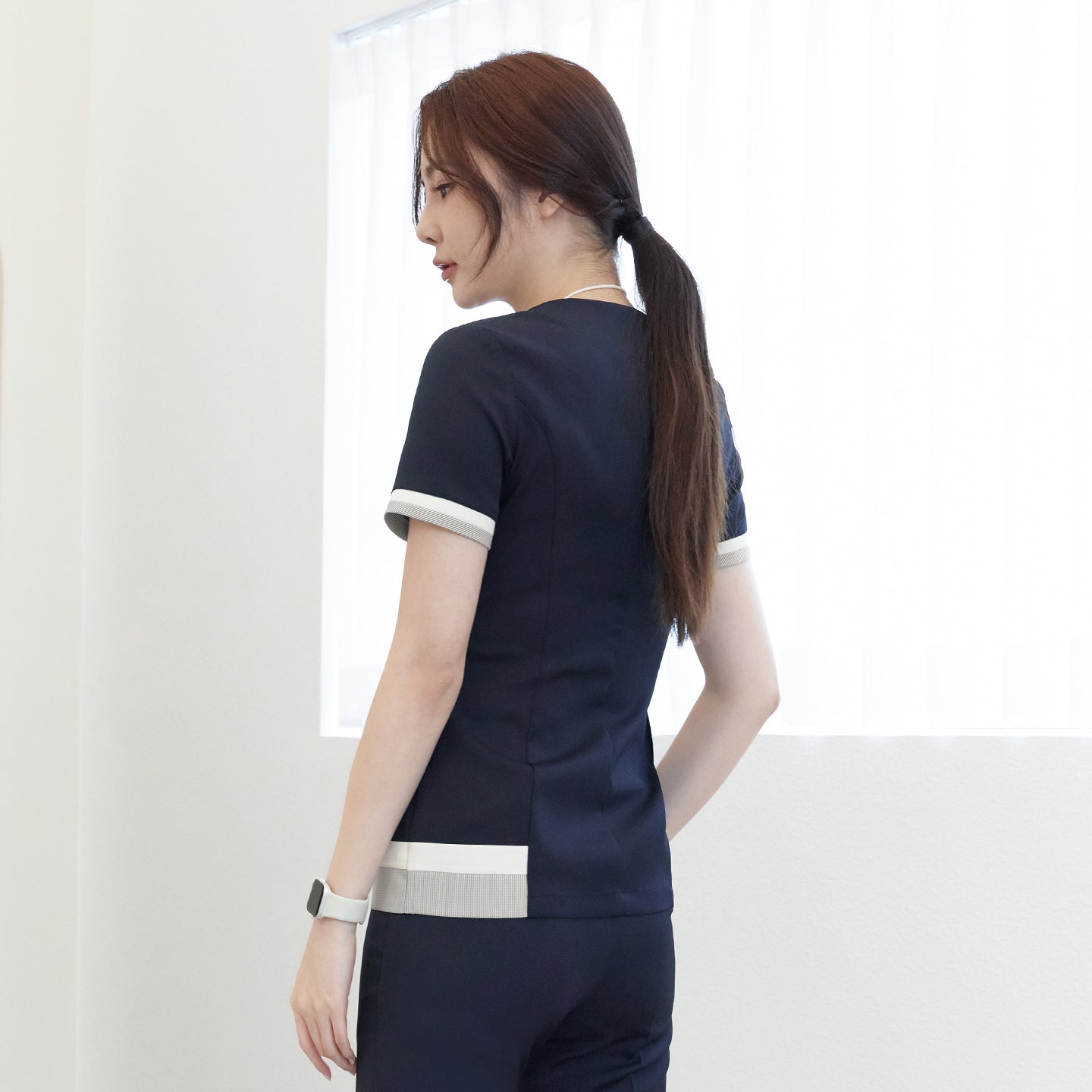 Image of Back view of TUL NS-168 Navy scrub top, highlighting subtle check pattern accents and a tailored fit.