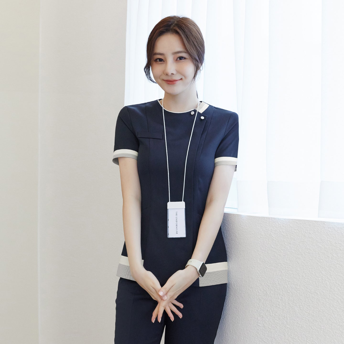 Image of Front view of TUL NS-168 Navy scrub top with subtle check detailing, short sleeves, and contrasting accent panels.