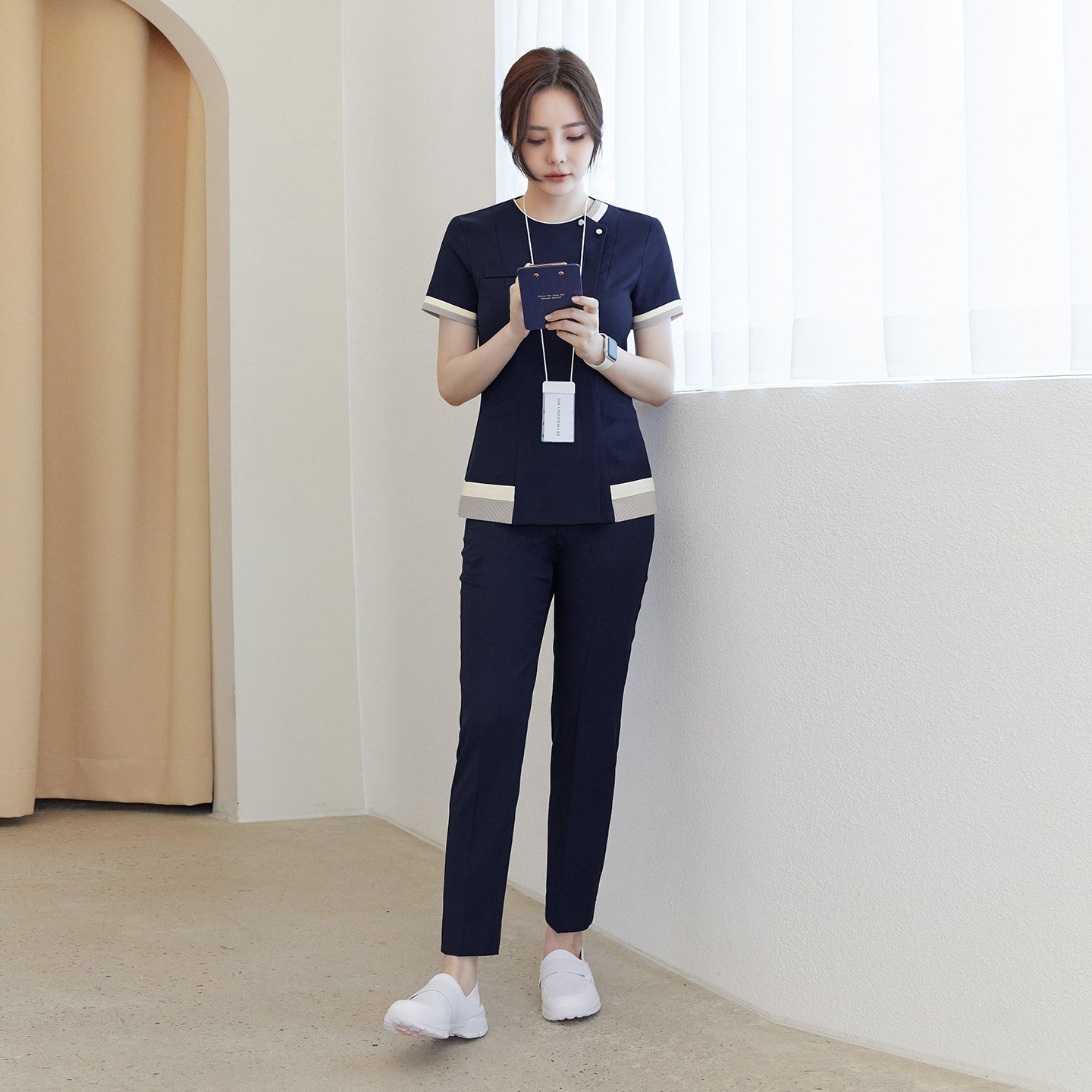 Image of Full-length shot of TUL NS-168 Women's Check Zipper Scrub Top in Navy, paired with matching pants for a cohesive professional uniform.