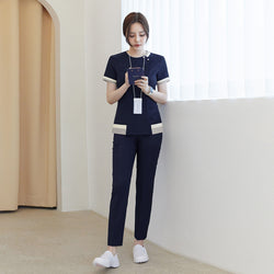 Image of Full-length shot of TUL NS-168 Women's Check Zipper Scrub Top in Navy, paired with matching pants for a cohesive professional uniform.
