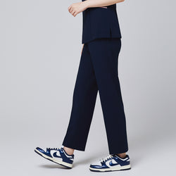 Image of Side of women's Pocket Banding Pants in Navy with matching scrub top and matching navy sneakers,Navy
