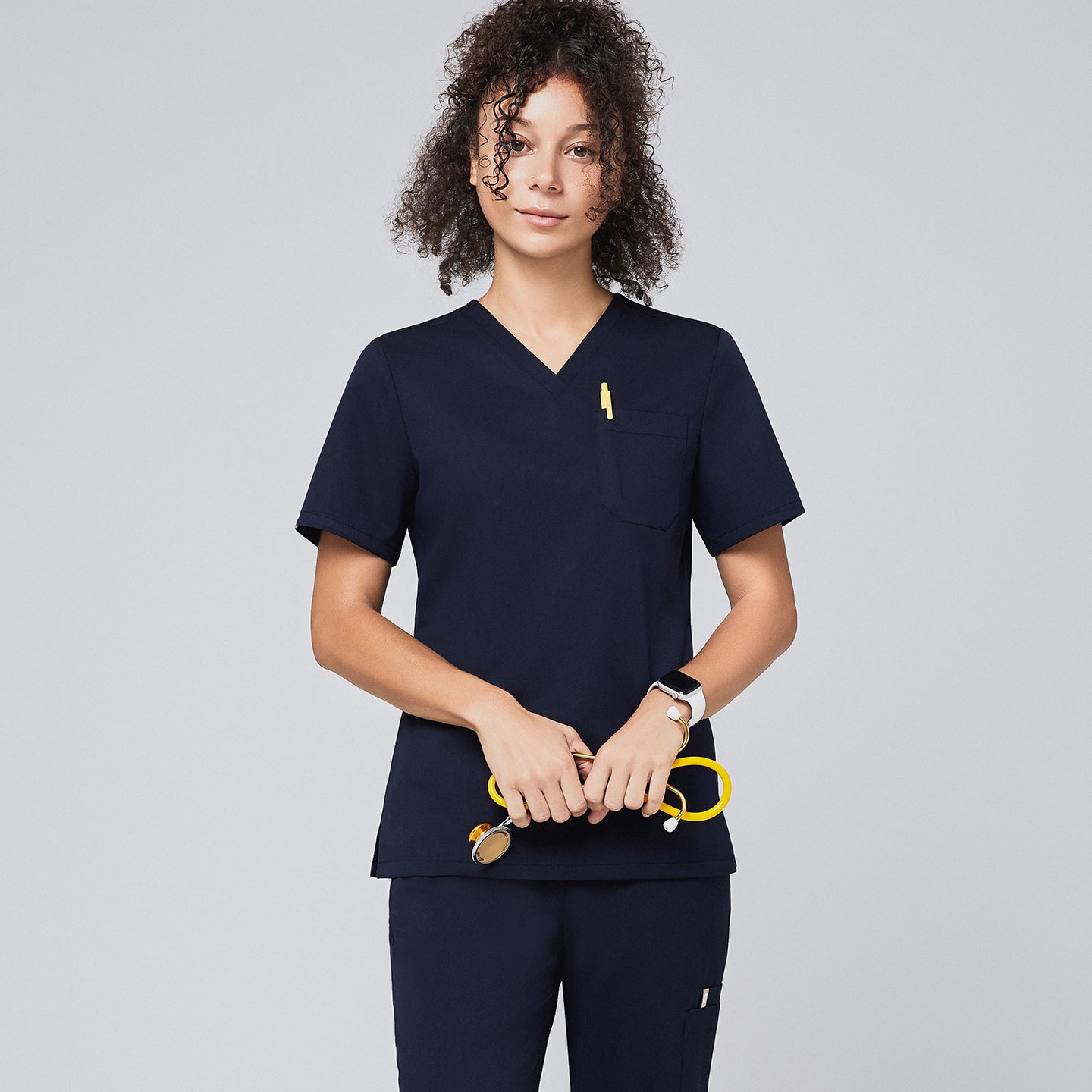 Image of Scrub Top with classic V-neck and chest pocket design, offering a clean professional look and comfortable fit.