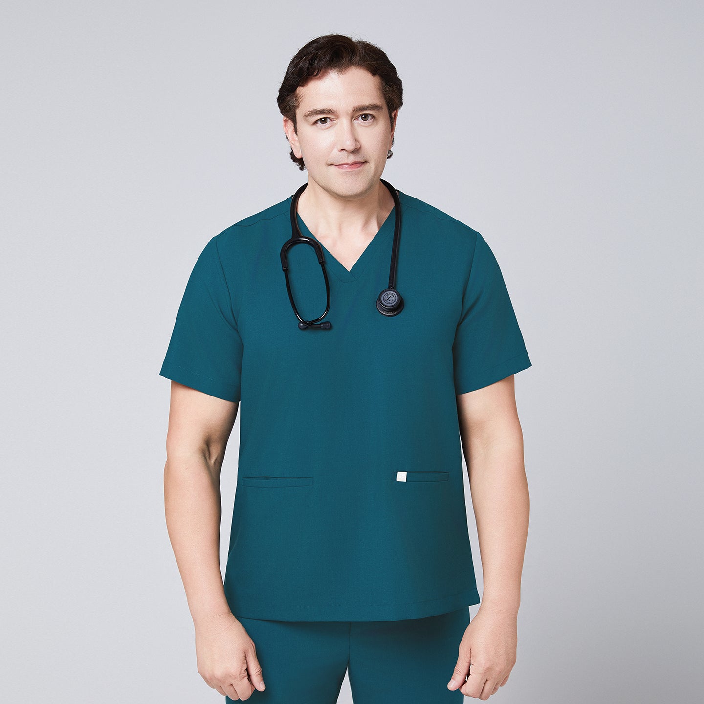 Ocean teal scrub top with two pockets and matching ocean teal straight scrub pants with black stethoscope over the neck,Ocean teal