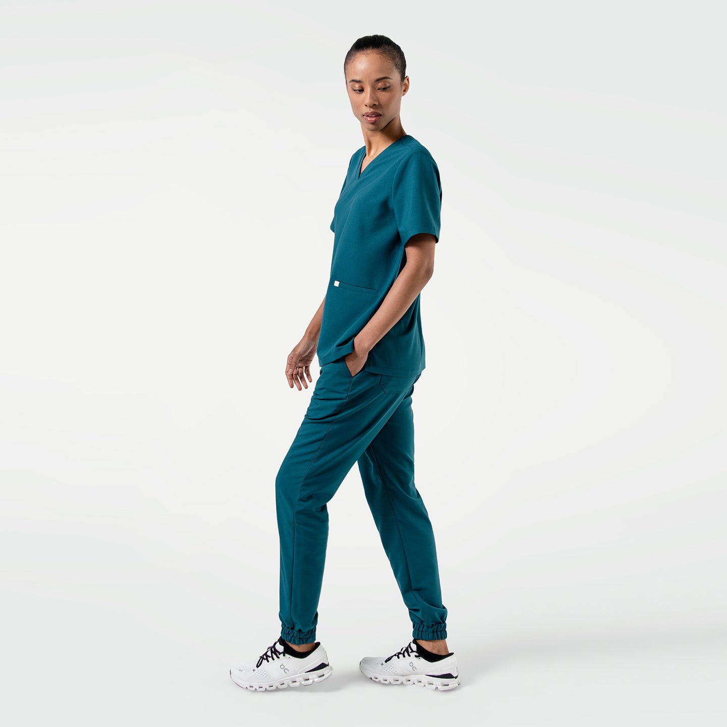 The Ocean Teal Double Pocket Scrub Top showcases a relaxed yet professional silhouette in a rich teal hue. De