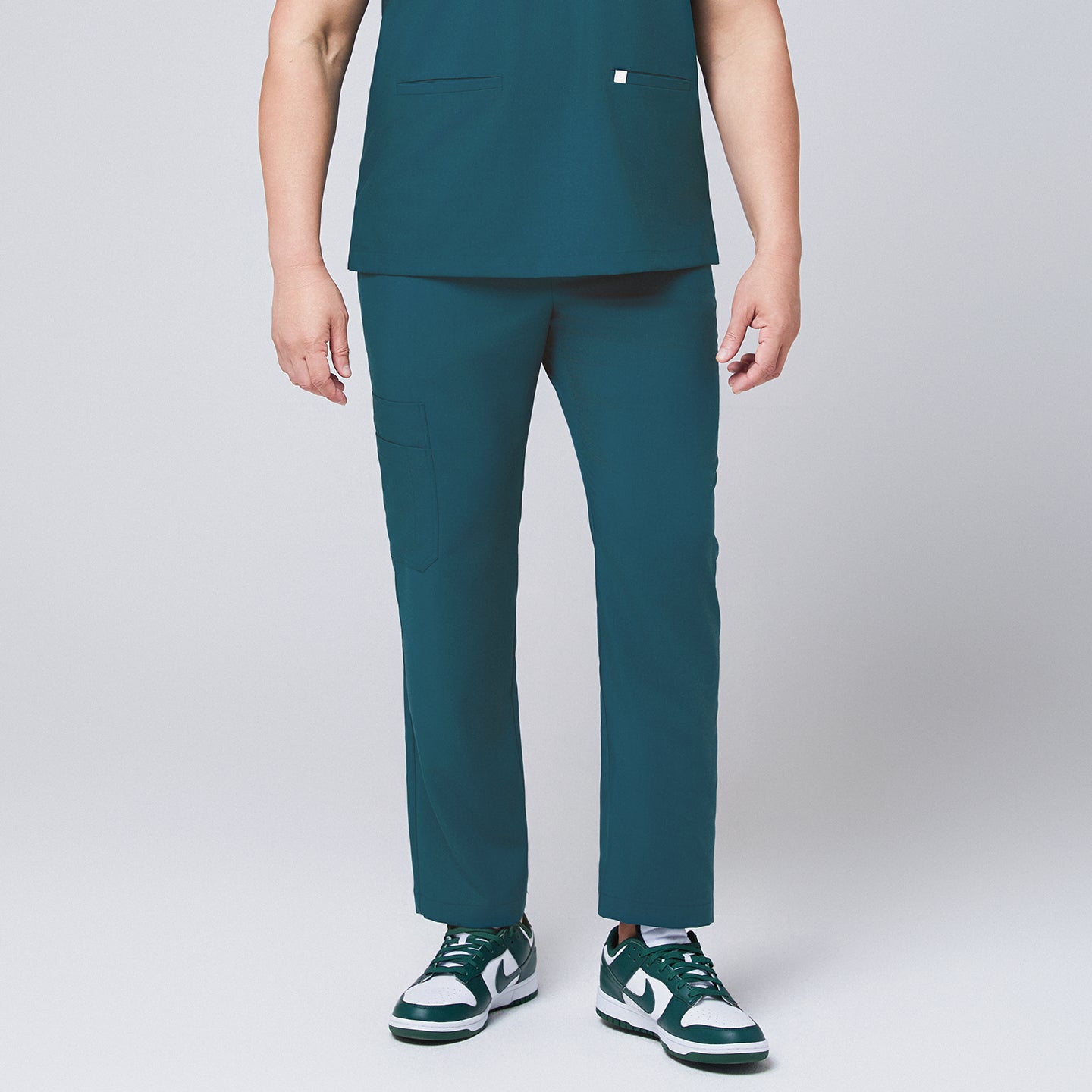 Image of Ocean teal straight scrub pants with side pockets and matching ocean teal scrub top, with teal sneakers,Ocean teal