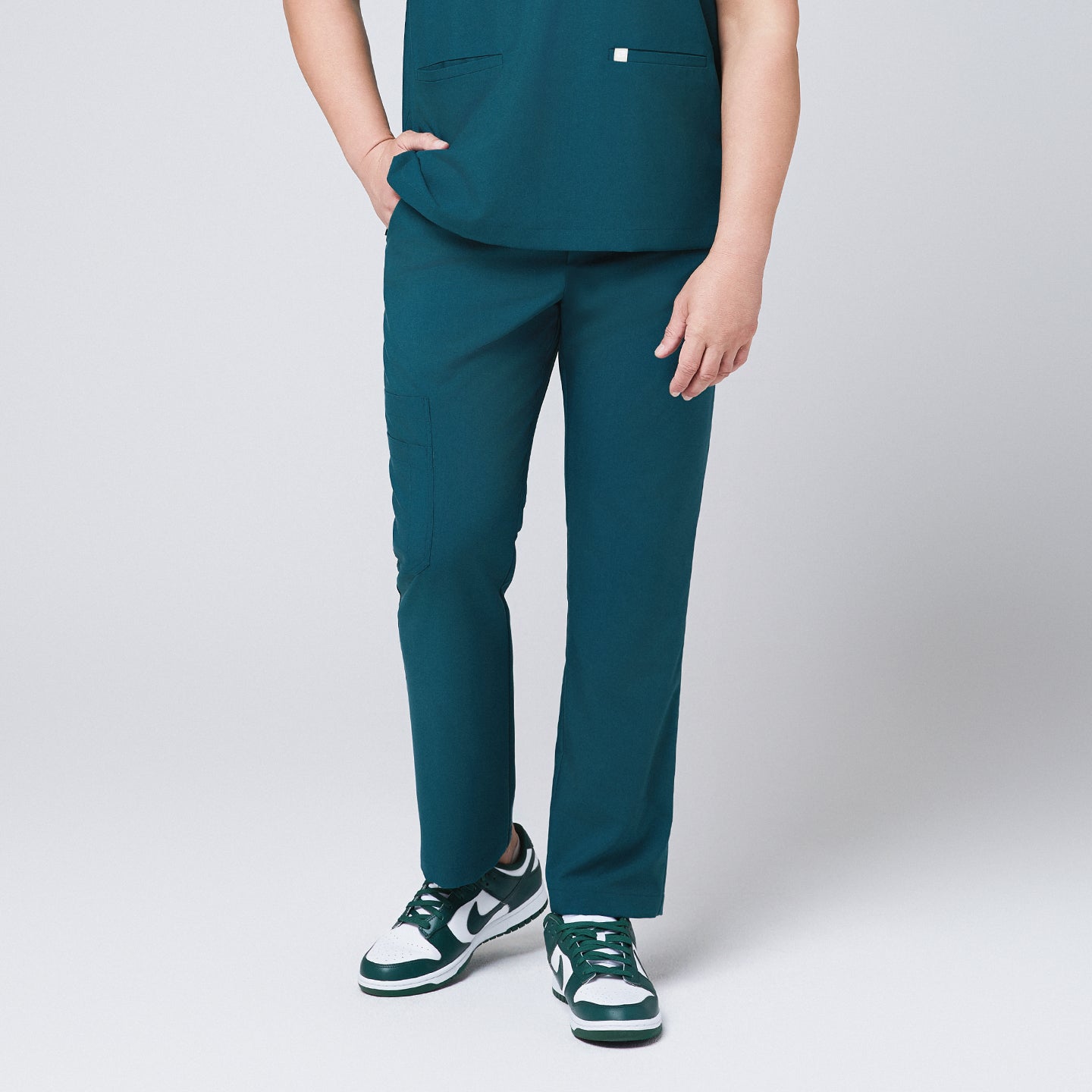 Image of Ocean teal straight scrub pants with side pockets and matching ocean teal scrub top, with teal sneakers,Ocean teal