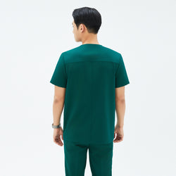 Image of Back view of TUL DS-191 Men's Pine Green scrub top, emphasizing structured seams and a comfortable short-sleeve design.