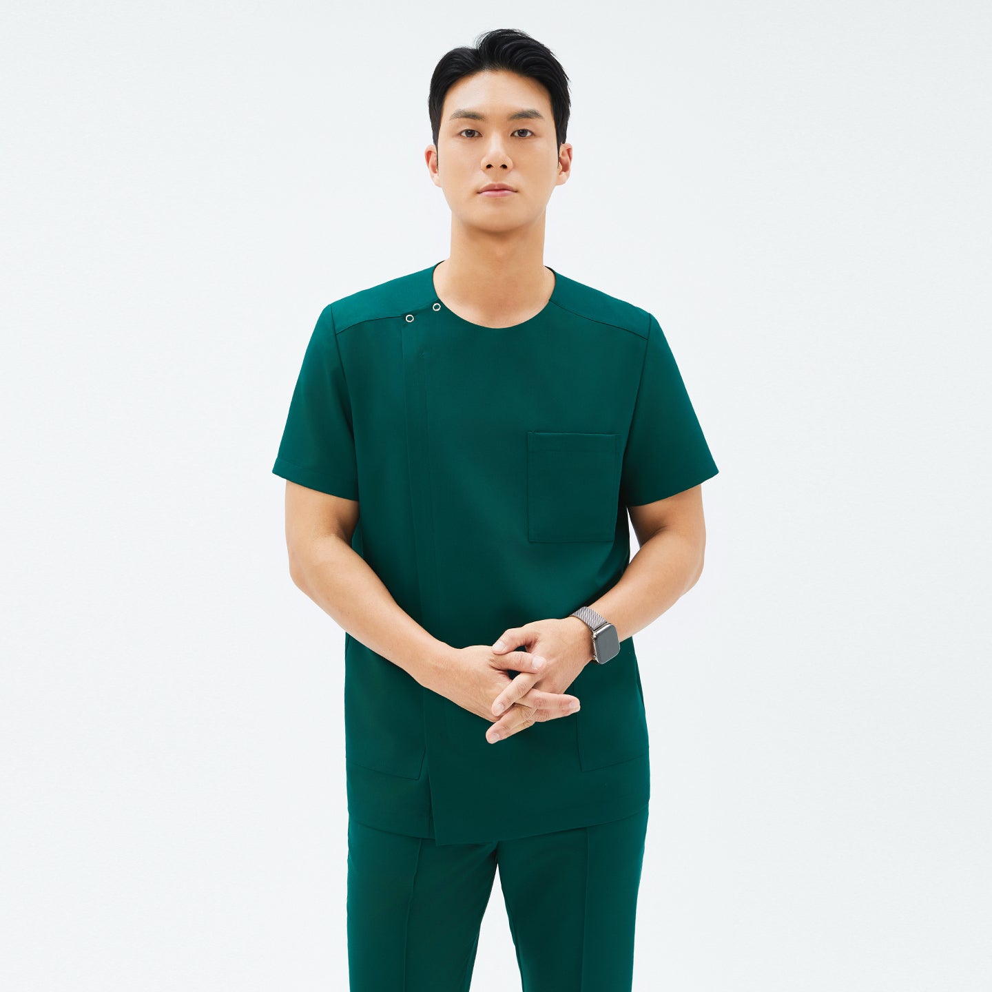 Front view of TUL DS-191 Men's Round Snap Zipper Scrub Top in Pine Green, showcasing a snap collar detail and modern silhouette.