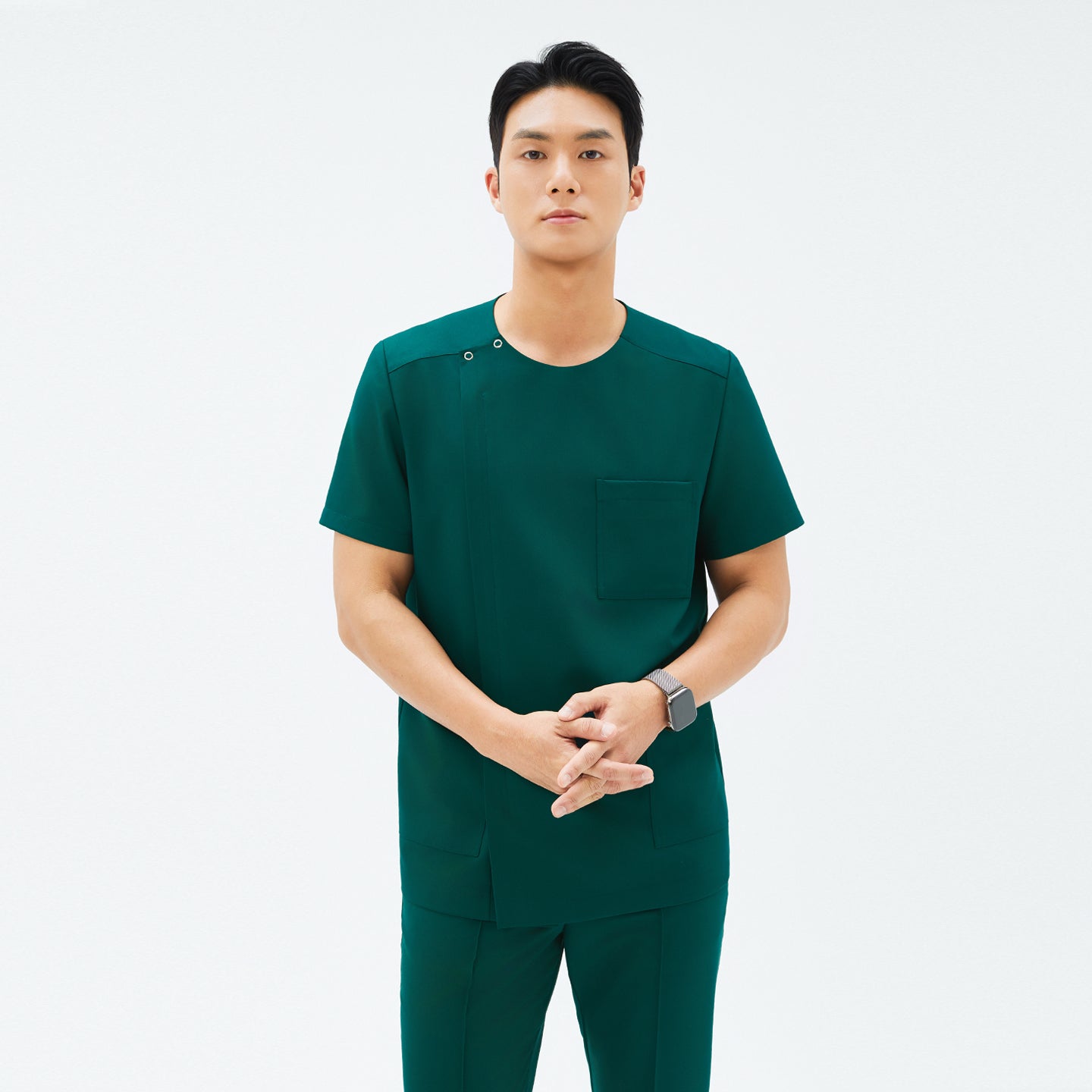 Image of Front view of TUL DS-191 Men's Round Snap Zipper Scrub Top in Pine Green, showcasing a snap collar detail and modern silhouette.