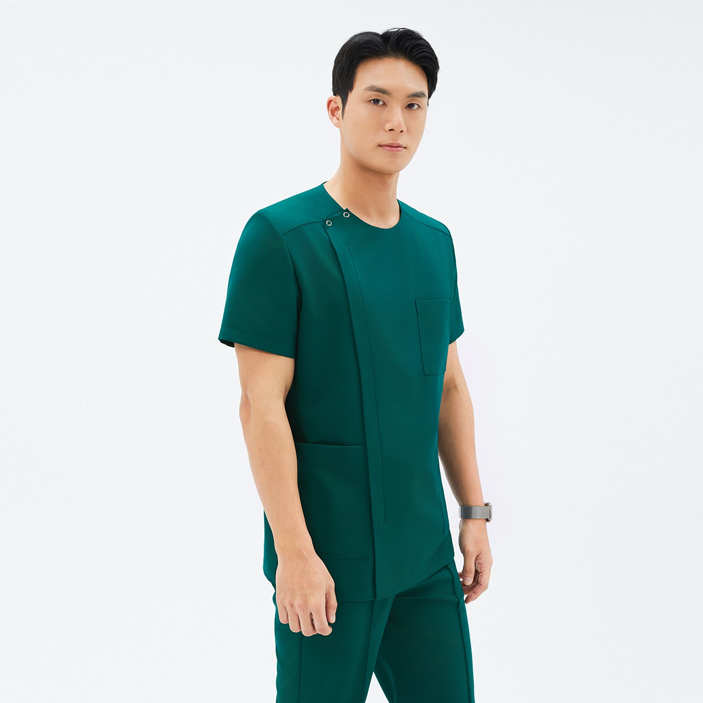 Image of Side angle of TUL DS-191 Pine Green scrub top, highlighting the round snap neckline, front zipper, and spacious pockets.