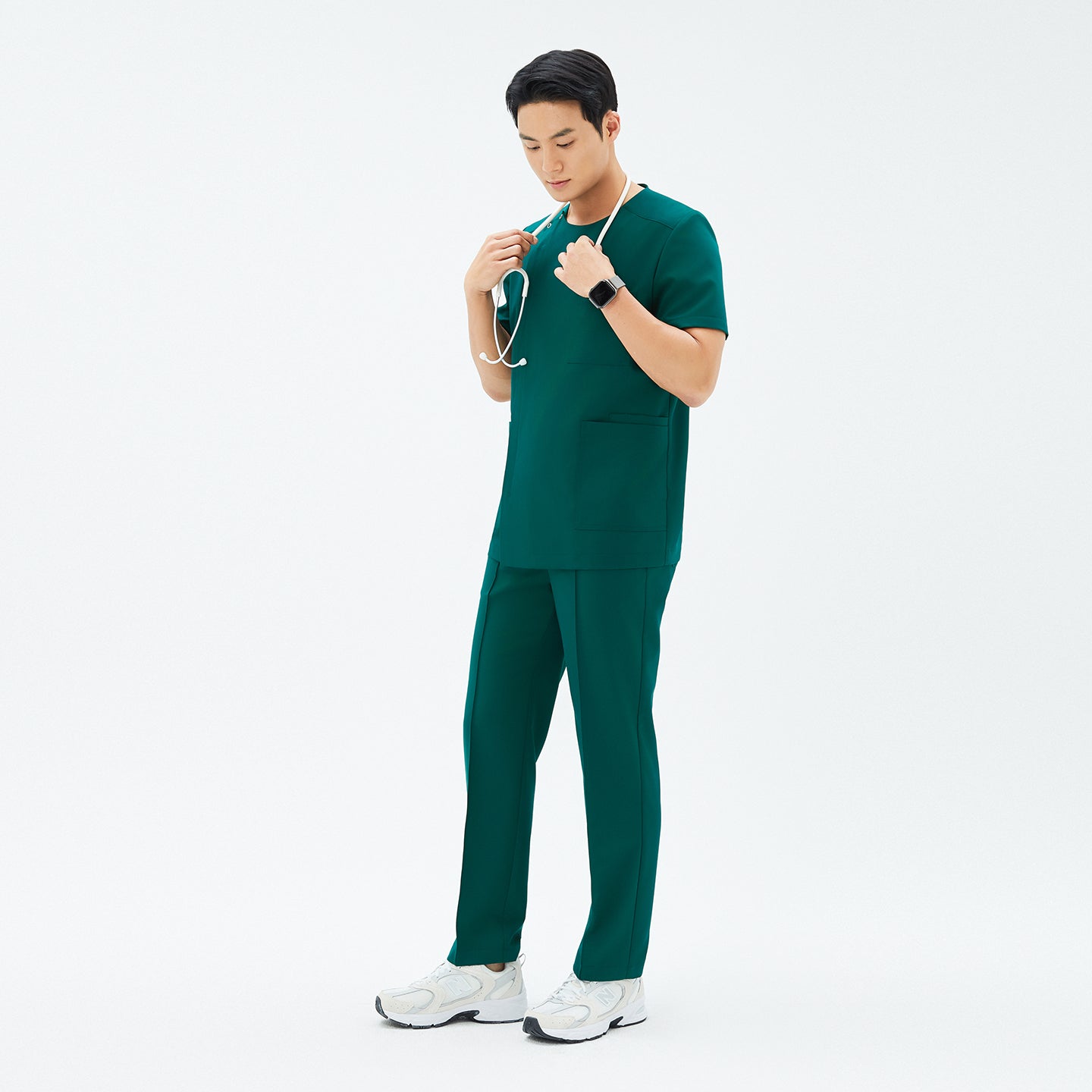 Image of Full-length shot of TUL DS-191 Men's Round Snap Zipper Scrub Top in Pine Green, paired with matching pants for a cohesive uniform look.