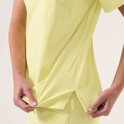 Image of Close-up of the Women's Pineapple Yellow Single Pocket Scrub Top showing side slit detail