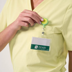 Image of Chest pocket detail on the Women's Pineapple Yellow Single Pocket Scrub Top with ID badge attachment, close-up shot