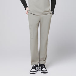 Image of Sand khaki straight-leg scrub pants with a side pocket, paired with a matching top and black-and-white sneakers,Sand Khaki
