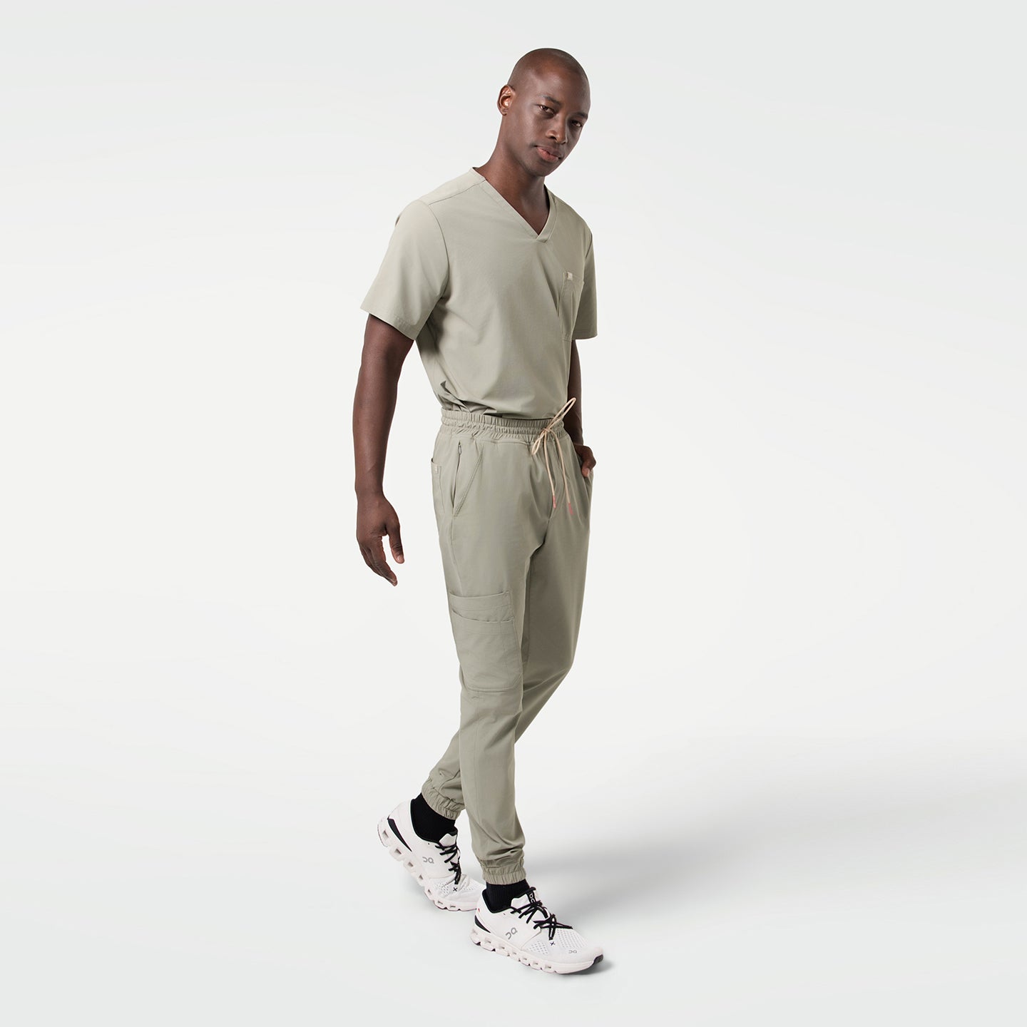 Image of The Sand Khaki Single Pocket Scrub Top features a sleek minimalist design with a soft neutral tone.