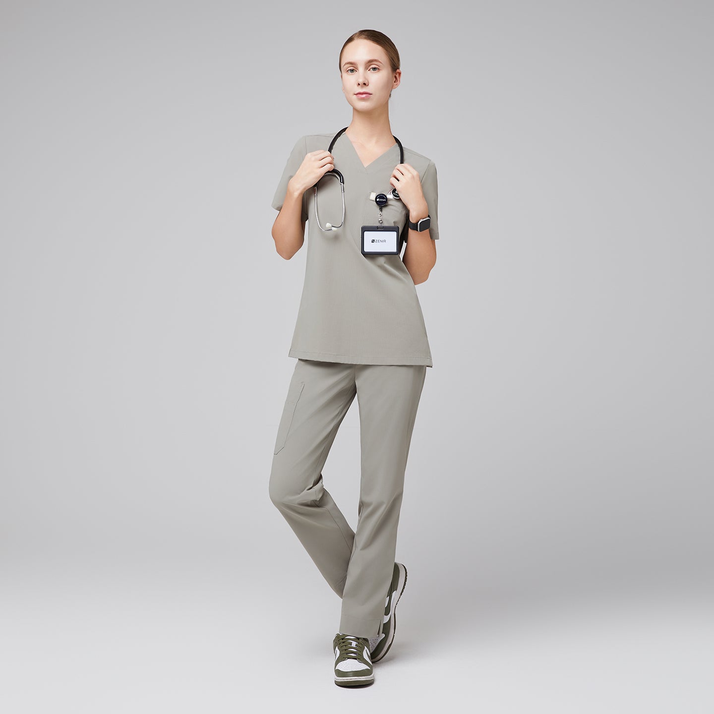 Image of Female wearing sand khaki V-neck scrub set with stethoscope and green sneakers,Sand Khaki
